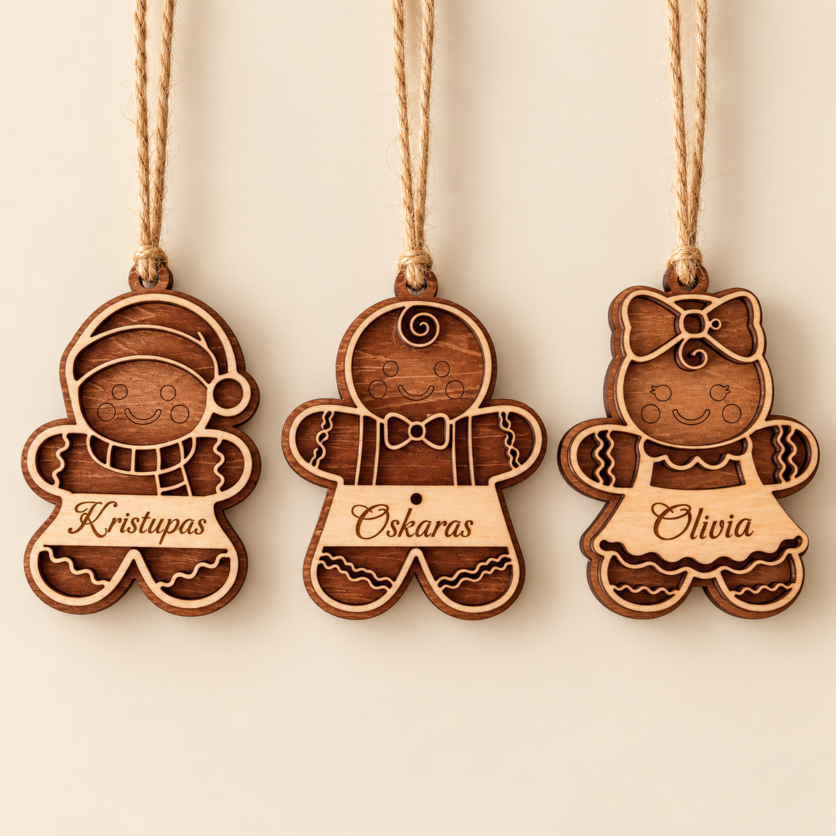 Three personalised gingerbread Christmas ornaments on a clean neutral background